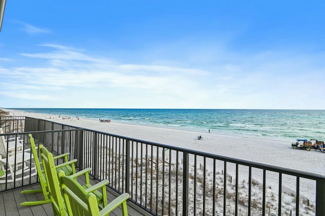 balcony with a beach view and a water view