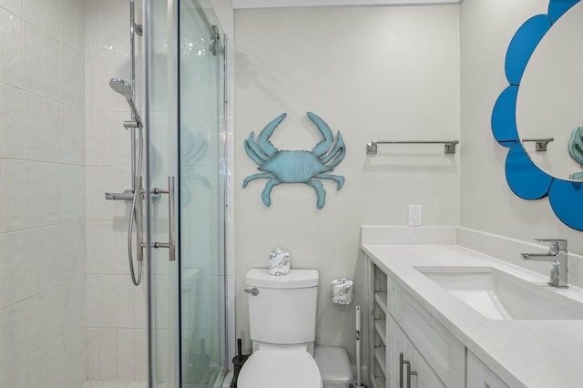 bathroom featuring vanity, toilet, and a stall shower