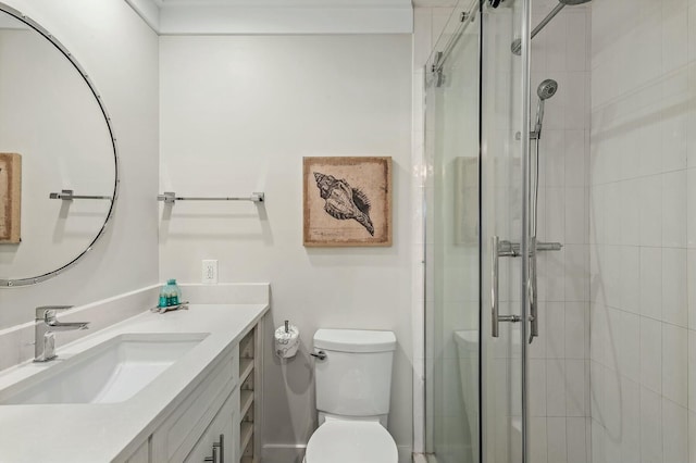 bathroom with a shower stall, vanity, and toilet