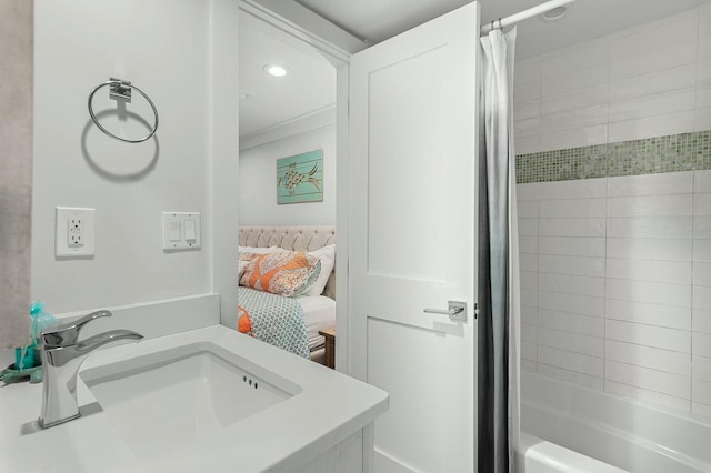 bathroom featuring ensuite bath, shower / tub combo, recessed lighting, and a sink