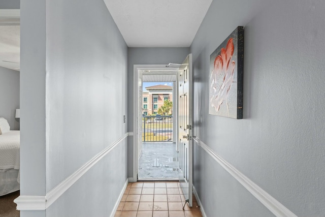 entryway with light tile patterned floors and baseboards