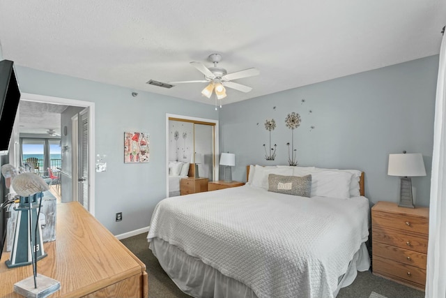 bedroom with carpet, baseboards, visible vents, ceiling fan, and a closet