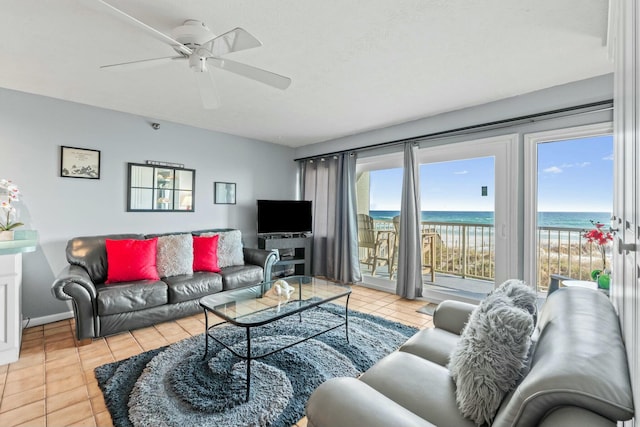 living room featuring a wealth of natural light, a ceiling fan, and tile patterned flooring