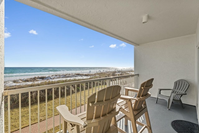 balcony with a beach view and a water view