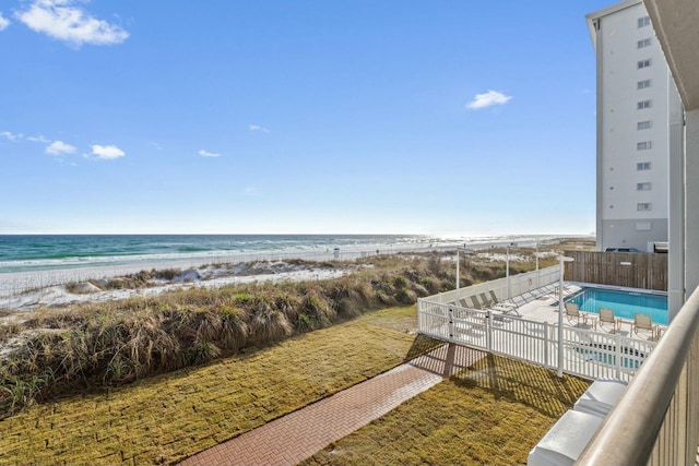 water view with fence and a view of the beach