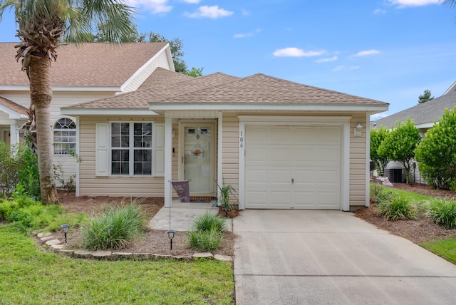 single story home featuring concrete driveway, a garage, and roof with shingles