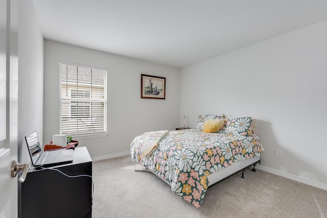 carpeted bedroom featuring baseboards