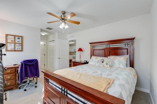 bedroom with a closet, visible vents, carpet flooring, and baseboards