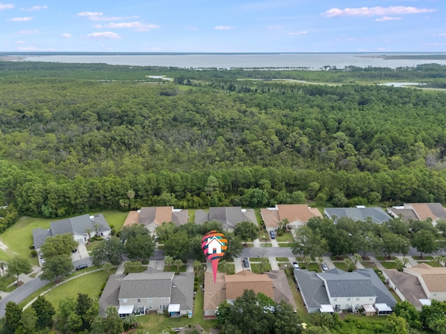 aerial view with a forest view, a water view, and a residential view