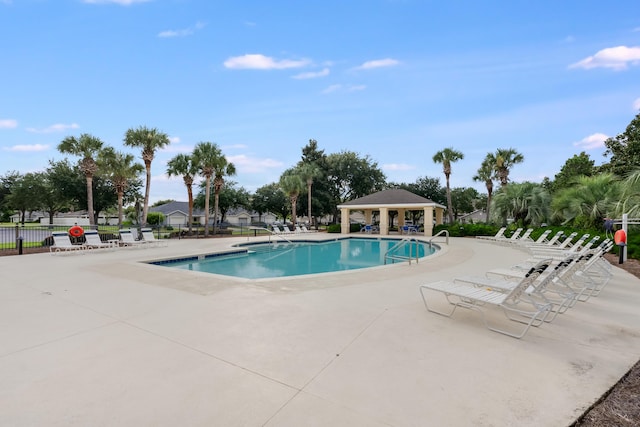 pool with a gazebo, a patio, and fence