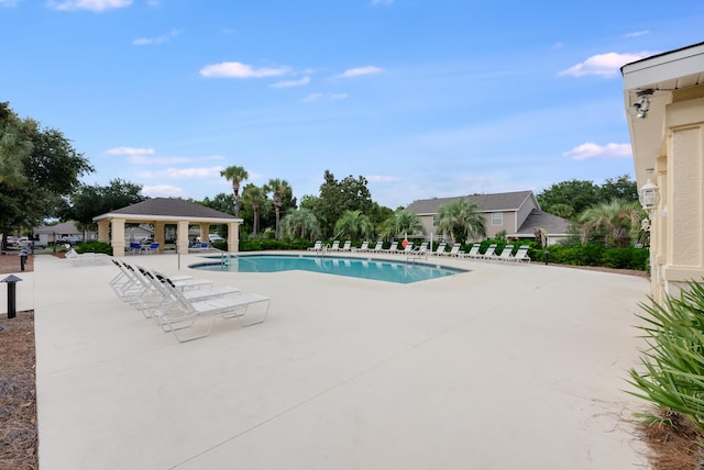 pool with a gazebo and a patio area