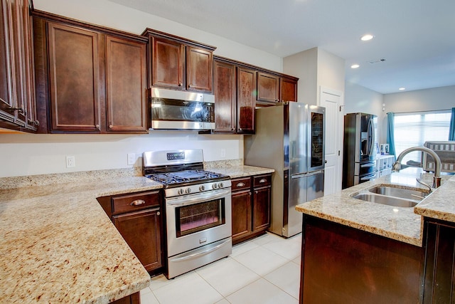 kitchen featuring visible vents, light tile patterned flooring, recessed lighting, a sink, and stainless steel appliances