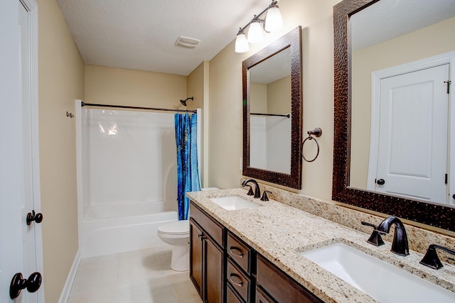bathroom featuring a textured ceiling, shower / tub combo with curtain, and a sink