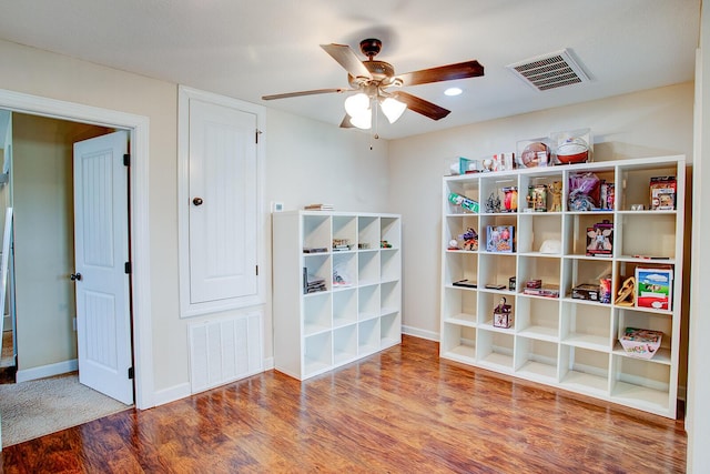 interior space with visible vents, baseboards, ceiling fan, and wood finished floors