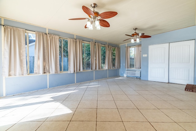 unfurnished sunroom featuring cooling unit and ceiling fan