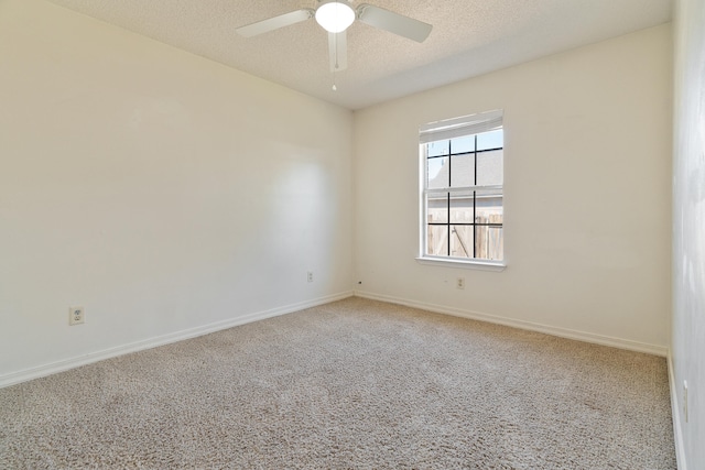 empty room with baseboards, carpet floors, a textured ceiling, and a ceiling fan