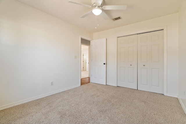 unfurnished bedroom with visible vents, carpet flooring, baseboards, and ceiling fan