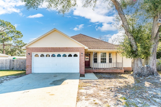 ranch-style house with a porch, fence, brick siding, and driveway