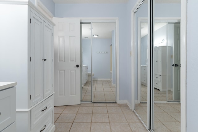 bathroom featuring tile patterned flooring, toilet, and vanity