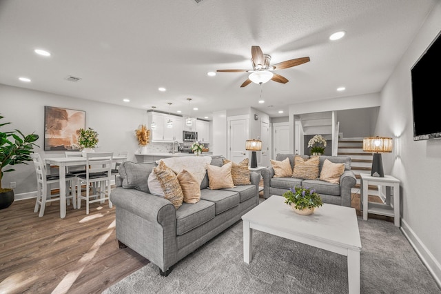 living room with recessed lighting, baseboards, and ceiling fan