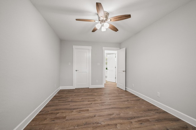 unfurnished bedroom featuring a ceiling fan, baseboards, and wood finished floors