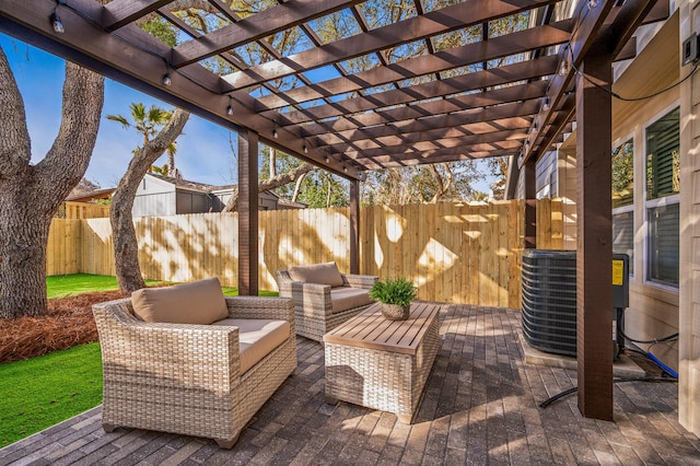 view of patio with outdoor lounge area, central AC unit, a fenced backyard, and a pergola