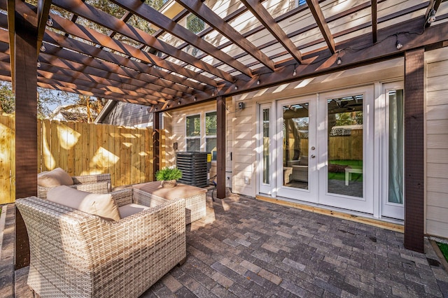 view of patio / terrace with a pergola, french doors, and fence