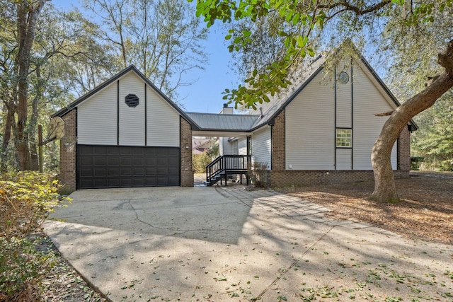 view of front facade with an attached garage, brick siding, and driveway