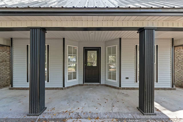 view of exterior entry featuring covered porch