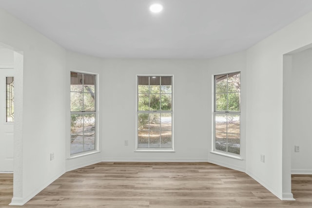 empty room featuring light wood-style flooring and baseboards