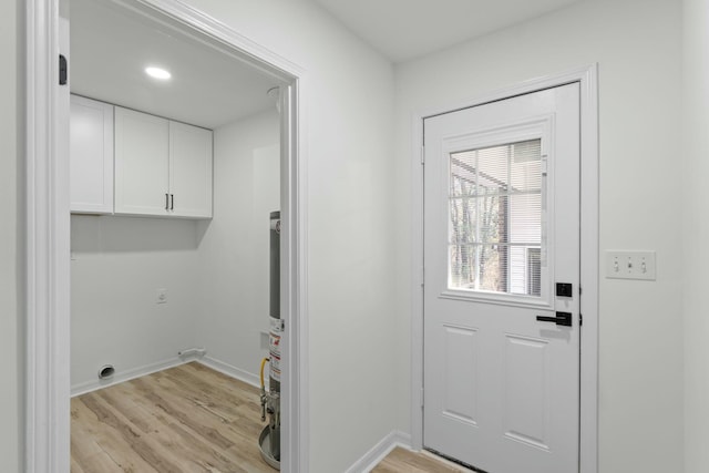 entryway with baseboards and light wood-style floors