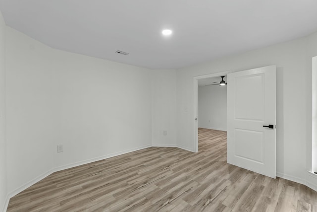 unfurnished room with visible vents, ceiling fan, baseboards, and light wood-style floors