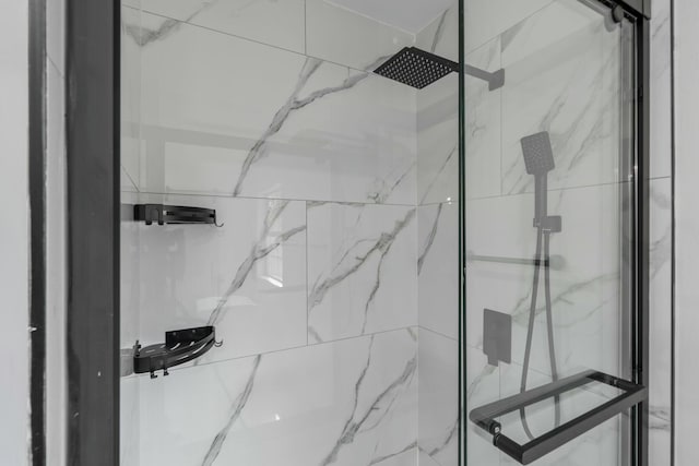 full bath with a marble finish shower