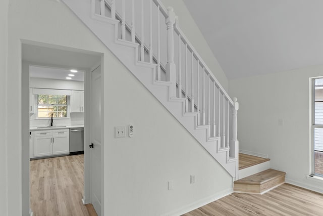 staircase with wood finished floors and baseboards