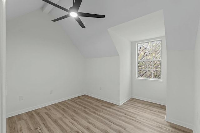 additional living space featuring baseboards, ceiling fan, vaulted ceiling with beams, and light wood finished floors