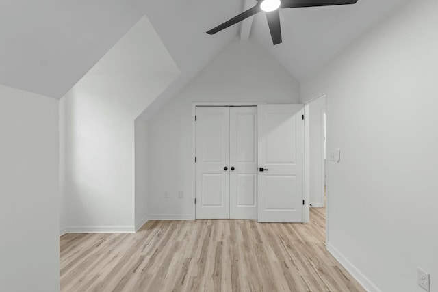 bonus room with baseboards, vaulted ceiling with beams, light wood-style floors, and ceiling fan