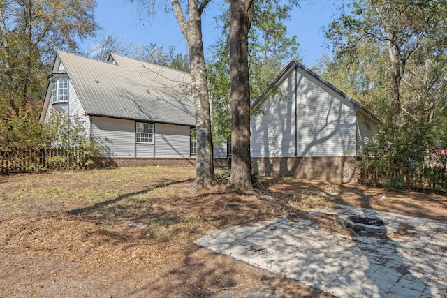 rear view of property with an outdoor fire pit