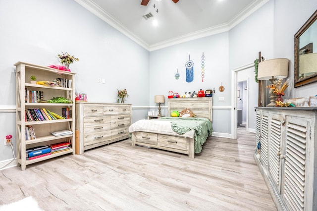 bedroom with visible vents, crown molding, baseboards, wood finished floors, and a ceiling fan