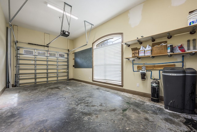 garage with a garage door opener and baseboards