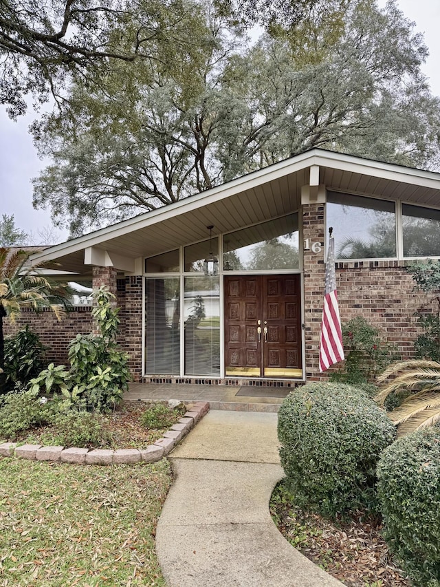 property entrance with brick siding