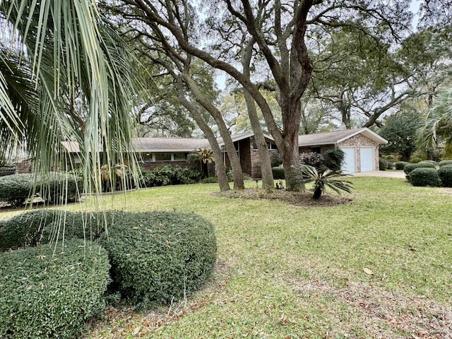 view of front of home with a garage and a front lawn