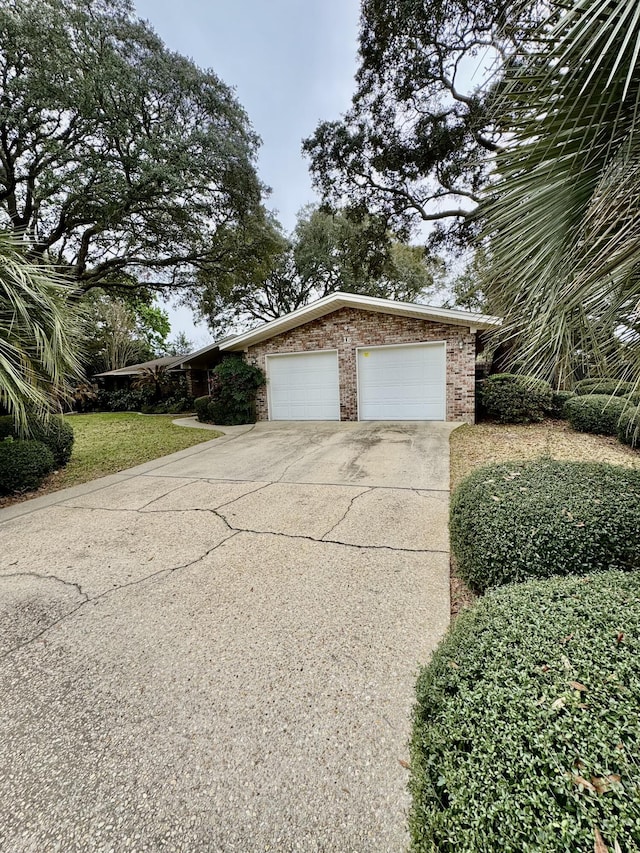 garage featuring concrete driveway