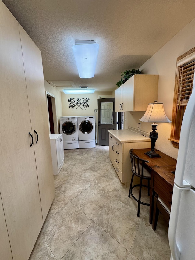 washroom with laundry area, washer and dryer, and a textured ceiling