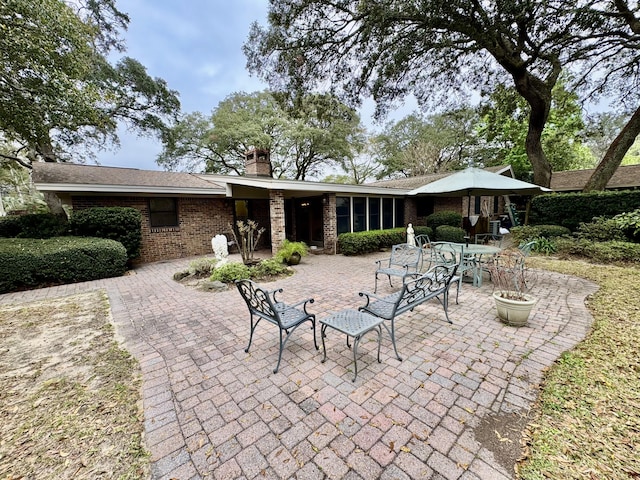 back of property with a patio and a chimney