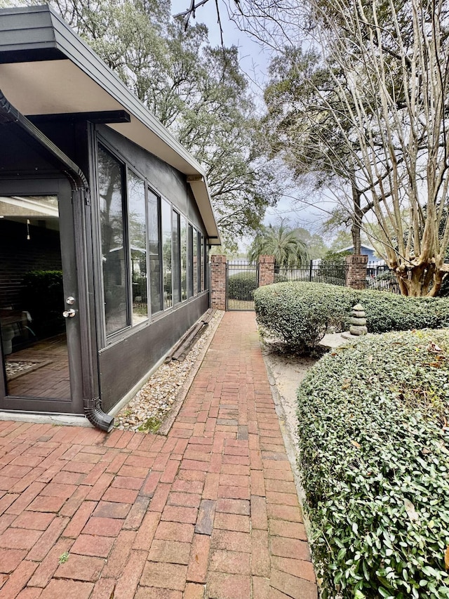 view of patio with a gate and fence