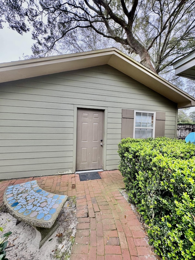 view of exterior entry with a patio area