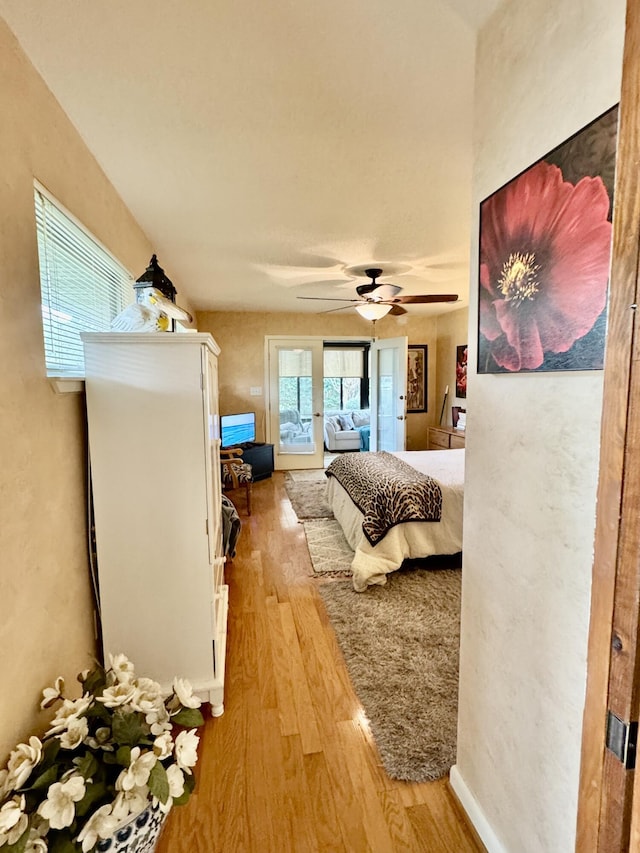 bedroom with ceiling fan and wood finished floors