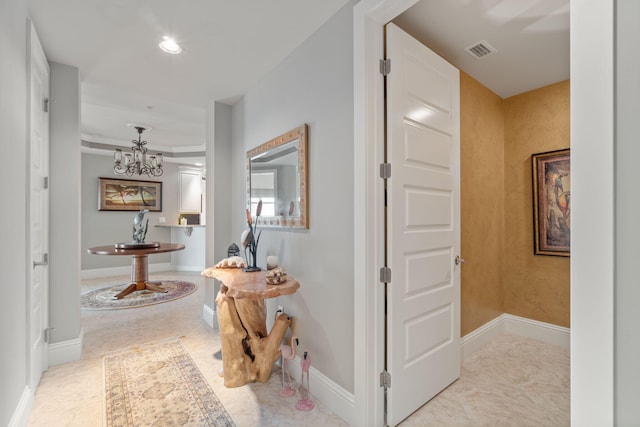 hall with an inviting chandelier, recessed lighting, baseboards, and visible vents