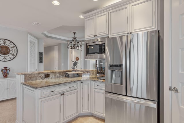 kitchen with visible vents, light stone counters, appliances with stainless steel finishes, a peninsula, and an inviting chandelier