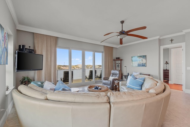 living area with baseboards, crown molding, and ceiling fan